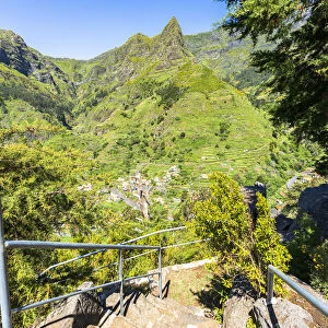 Steep steps on mountain path to the green alpine valley and village of Serra de Agua