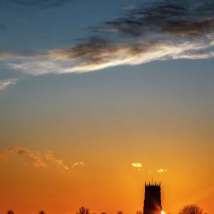 Sunset behind the Parish Church of the Holy Trinity and All Saints at Winterton on Sea