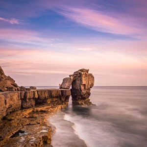Sunset at Pulpit Rock, limestone sea stack on heavily quarried coast of Portland Bill