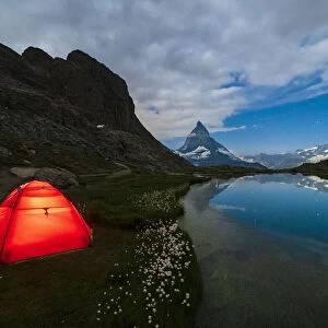 Tent on the shore of lake Riffelsee facing the Matterhorn, Zermatt, canton of Valais