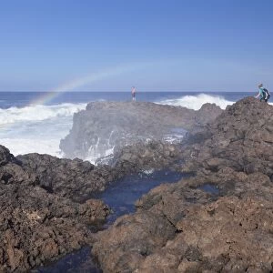 Tourists watching waves at the coast of La Fajana, Barlovento, Canary Islands, Spain