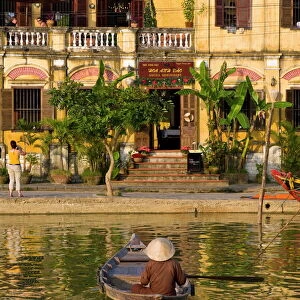 Traditionally dressed old man sitting in his little fishing boat, Hoi An