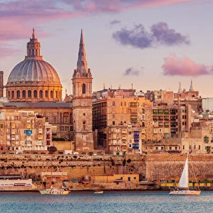 Valletta skyline at sunset with the Carmelite Church dome and St. Pauls Anglican Cathedral, Valletta, Malta, Mediterranean, Europe