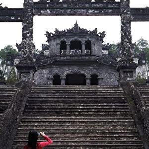 Vietnamese schoolgirl taking picture of Khai Dinhs Tomb, Hue, Vietnam