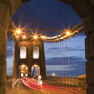 View along the A5 road at night across the Menai suspension bridge, built by Thomas Telford in 1825