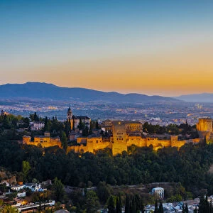View of Alhambra, UNESCO World Heritage Site, and Sierra Nevada mountains at dusk