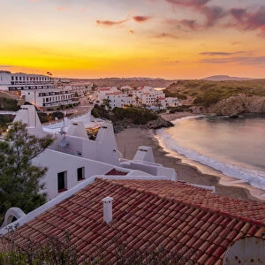 View of beach and rooftops at sunset in Arenal d en Castell, Es Mercadal, Menorca, Balearic Islands, Spain, Mediterranean, Europe