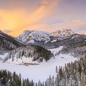 View by drone of sunset over Monte Piana and woods covered with snow, Misurina, Dolomites