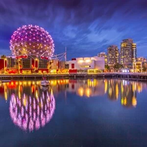 View of False Creek and Vancouver skyline, including World of Science Dome at dusk
