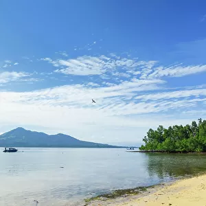 View to mainland and Gunung Tumpa at an eastern beach on this coral fringed holiday island, Bunaken, North Sulawesi, Indonesia, Southeast Asia, Asia