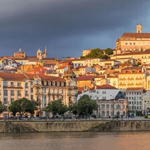 View from Mondego River to the old town with the university on top of the hill at sunset