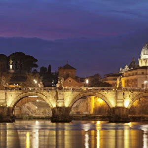 View over Tiber River to Ponte Vittorio Emanuele II Bridge and St. Peters Basilica