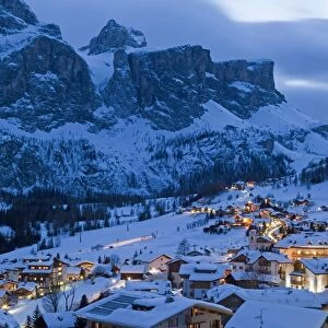 The village of Colfosco in Badia, 1645m, and Sella Massif range of mountains under winter snow