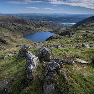 Walkers on Little How Crags above Levers Water on The Old Man of Coniston, Lake District National Park, UNESCO World Heritage Site, Cumbria, England, United Kingdom, Europe