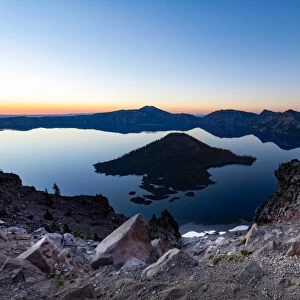 Wizard Island and the still waters of Crater Lake at dawn, the deepest lake in the U