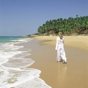 Woman tourist walking along the beach