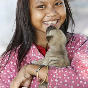 Young Cambodian girl and her little dog, Siem Reap, Cambodia, Indochina, Southeast Asia