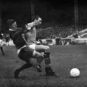 Bobby Noble and Mike Summerbee compete for the ball in the 1966 / 7 Manchester derby at Maine Road