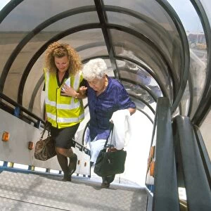 Passenger being helped up steps of British Airways aircraft in South Africa