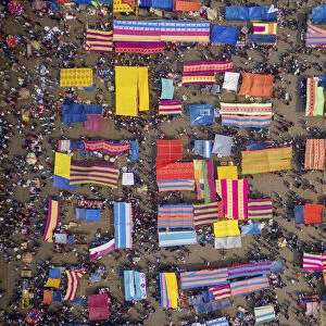 Aerial view of people in a traditional local fish market with colourful bazaars in