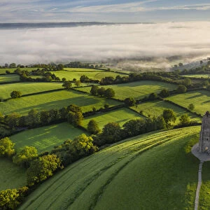 Aerial view of St Michaels Tower on Glastonbury Tor on a misty autumn morning