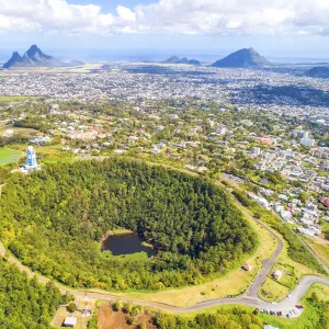 Aerial view of Trou Aux cerfs volcano crater with Curepipe city, Rempart mountain