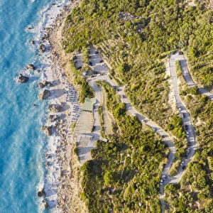 Aerial view of the winding road to Megali Petra beach. Lefkada, Ionian Islands region