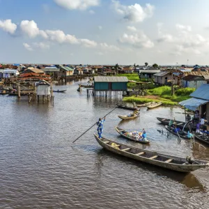 Africa, Benin, Ganvie. a scene on the main channel with boats, shops and stilt houses