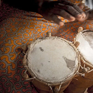 Africa, Benin, Porto Novo, Ajara. A drum player with a double bongo drum