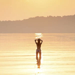 Asia, South East Asia, Cambodia, Koh Rong Samloem island, woman in a bikini silhouetted