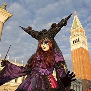 Beautiful costume and mask in front of Campanile at the Venice Carnival, Piazza San Marco