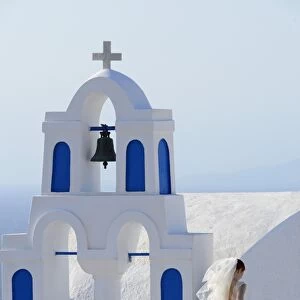 Bride walking past church, Santorini, Kyclades, South Aegean, Greece, Europe
