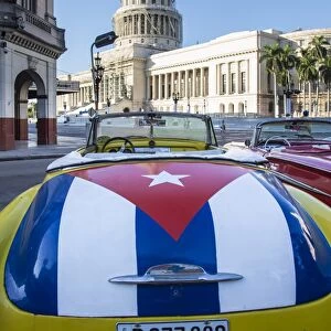 Classic American car with the Cuban flag painted in its boot, Parque Central, Havana