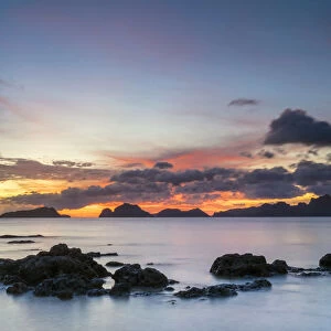 Colorful sunset over Bacuit Bay at Marimegmeg Beach, El Nido, Palawan, Philippines