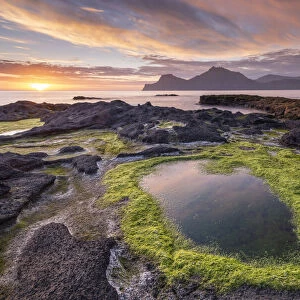 Colourful summer sunrise from the rocky shores of Gjogv on the island of Eysturoy