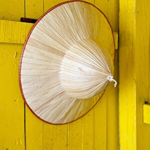 Conical hat hanging on a yellow wall, Halong Bay, Vietnam