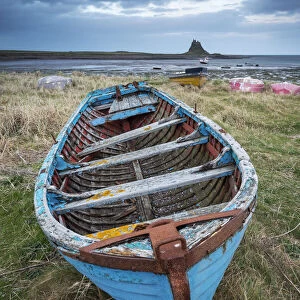 Decaying, rusty old boat on the shore of the Holy Island of Lindisfarne, Northumberland