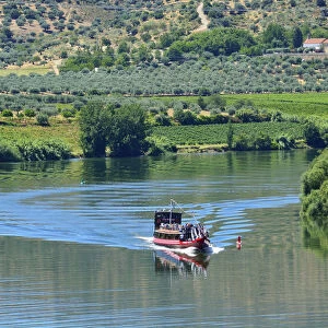 The Douro river and a tour boat at Pocinho, a Unesco World Heritage Site. Portugal