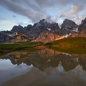 Enrosadira on Pale di San Martino Dolomites reflecting on the lake of Segantini hut