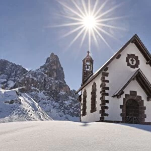 Europe, Italy, Trentino, Rolle pass. The small alpine church in a winter view