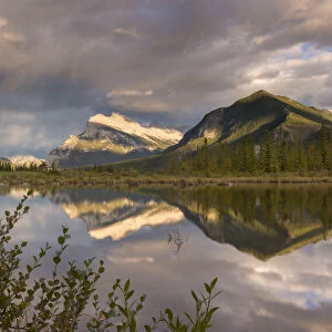 Evening light glows on Mount Rundle, reflected in Vermillion Lakes in the Canadian