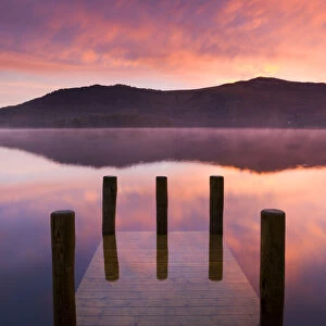 Fiery sunrise over Derwent Water from Hawes End jetty, Lake District National Park