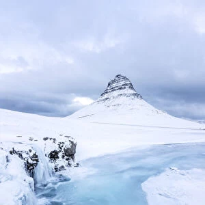 Iceland: Snaefellsnes peninsula: frozen waterfall under the Kirkjufell