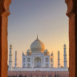 India, Taj Mahal at sunset framed by a temple arch