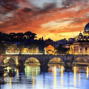 Italy, Rome, St. Peter Basilica by night reflecting on Tevere river