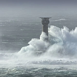 Large waves crashing over Longships Lighthouse, Lands End, Cornwall, England, UK