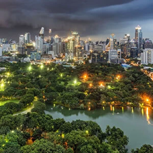 Lumpini Park and city skyline at dusk, Bangkok, Thailand