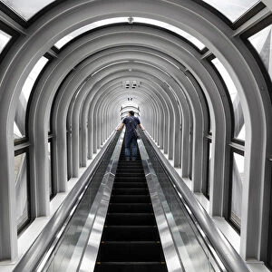 A man takes the escalator up the Umeda Sky building, Osaka, Kansai, Japan