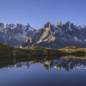 The Mont Blanc mountain range reflected in the waters of Lac de Chesery at sunrise