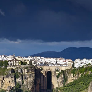 Moody storm clouds & contrasty light over Puento Nuevo & the White Village of Ronda